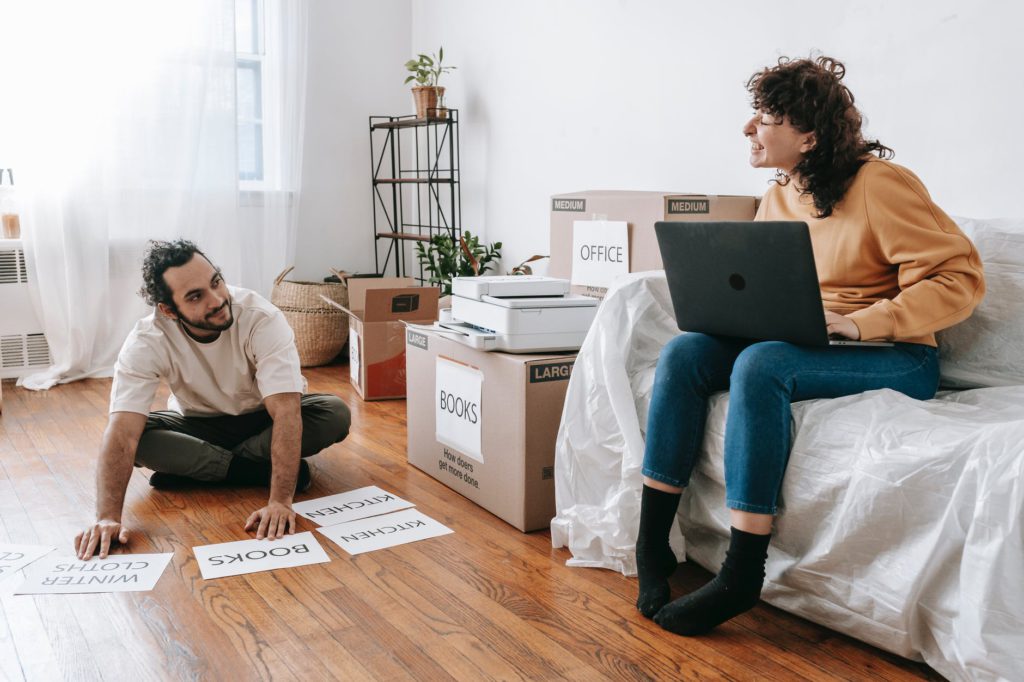 couple making printed labels for boxes