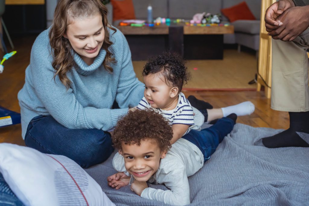 ethnic family playing with kids at home