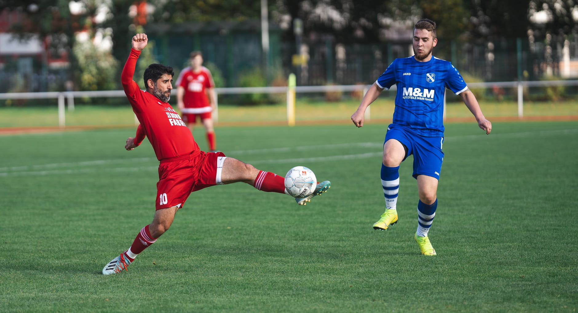 soccer players in red and blue jersey shirts