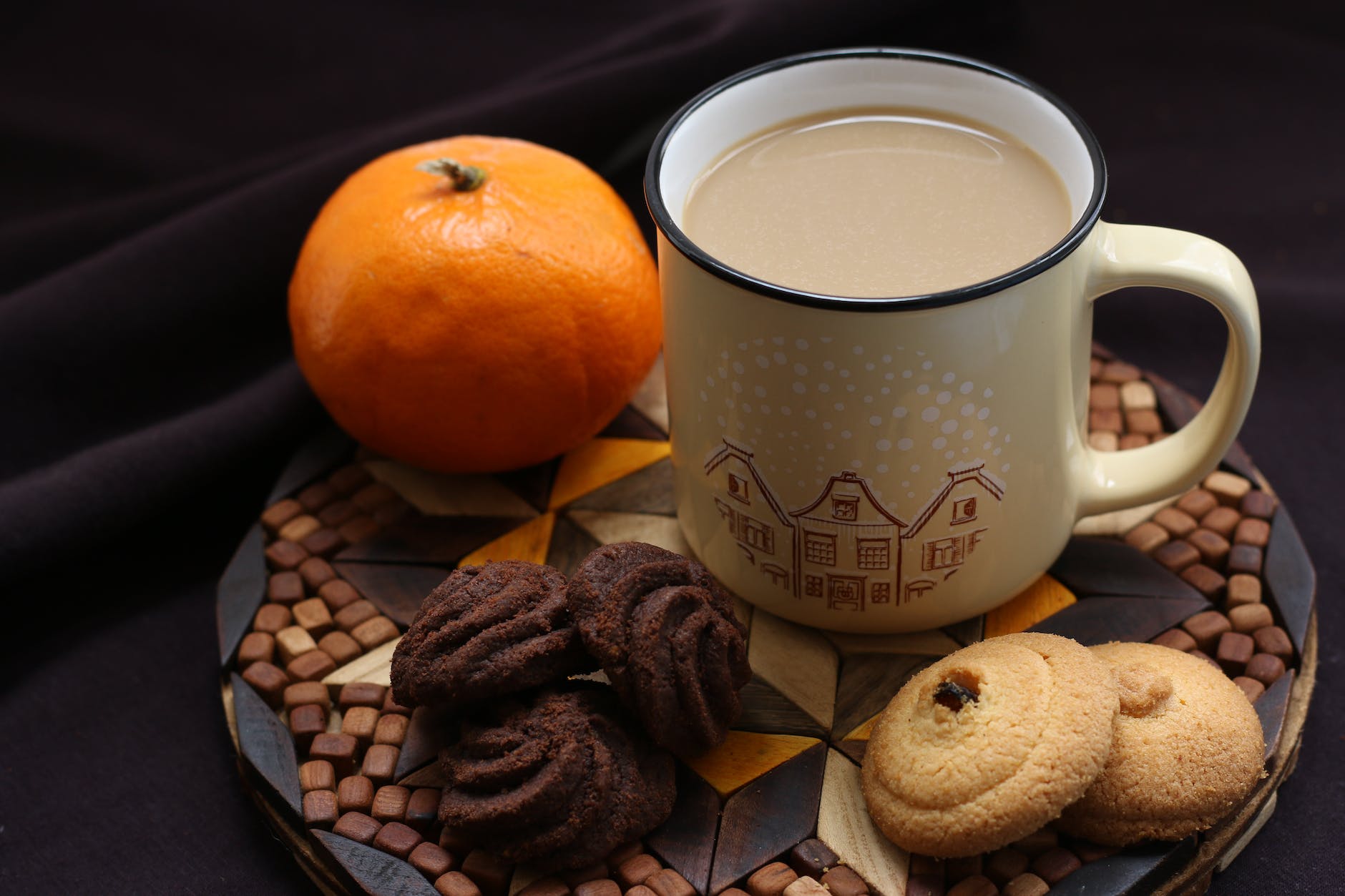 white ceramic mug beside orange fruit