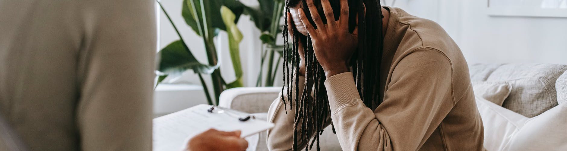 stressed black man with dreadlocks in psychological office