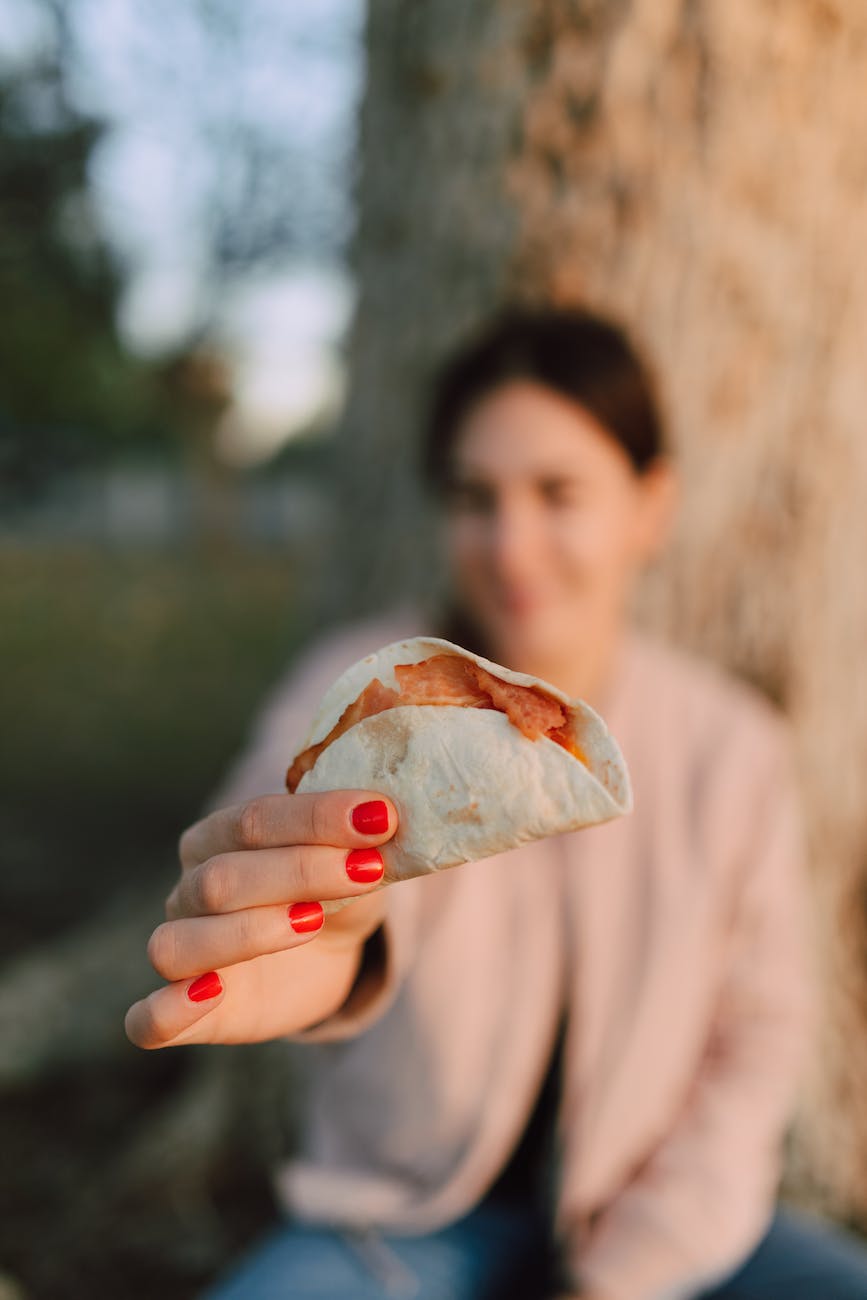 person holding a tacos
