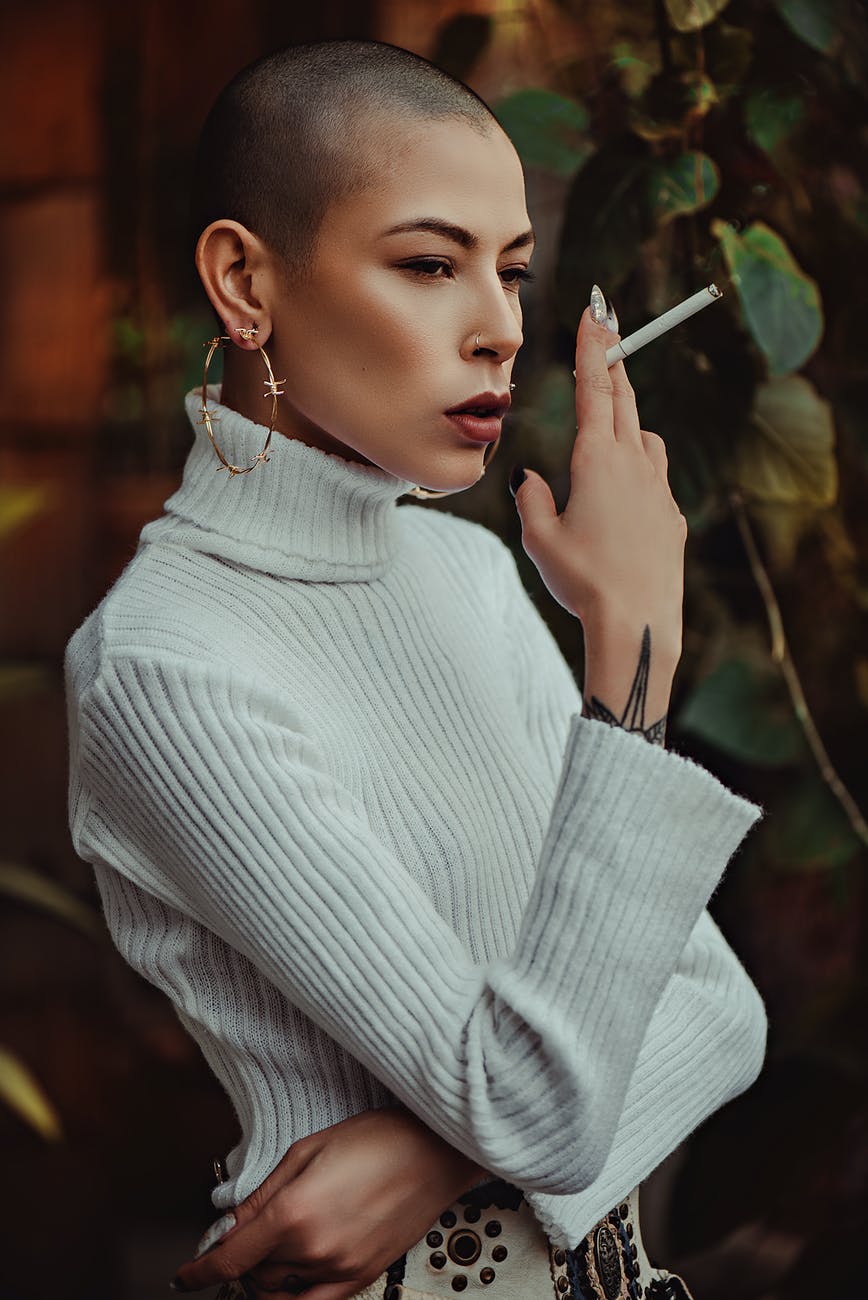 photo of woman holding cigarette