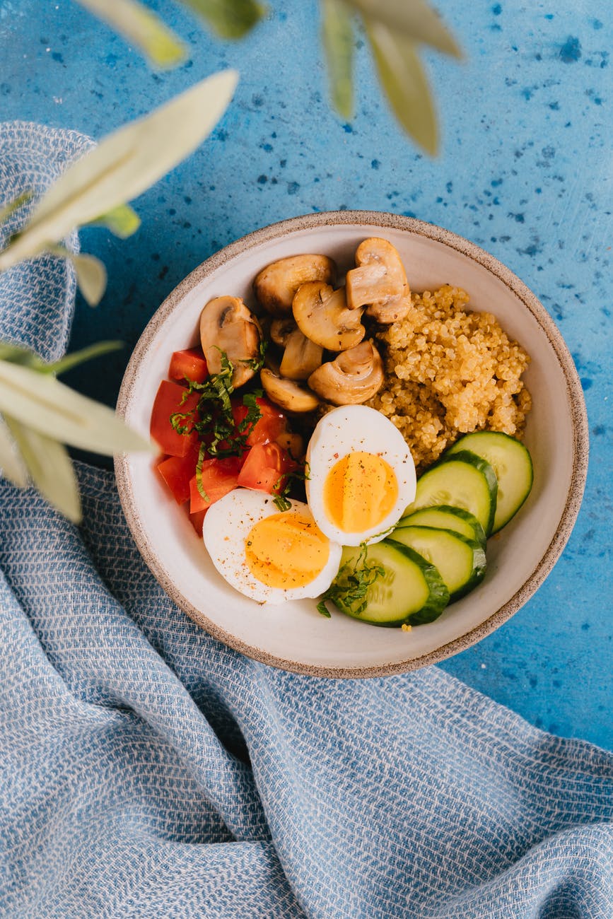 sliced cucumber and tomatoes on white ceramic bowl