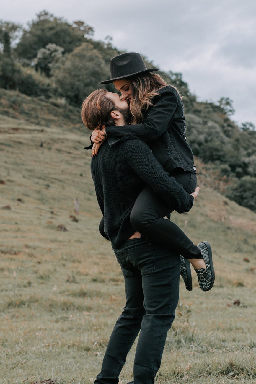 man carrying woman
