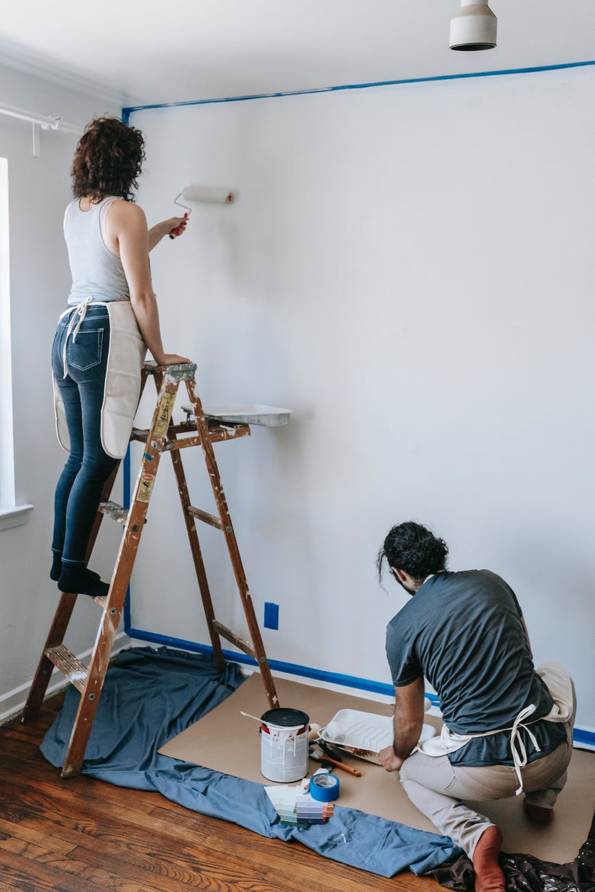 couple painting the wall white