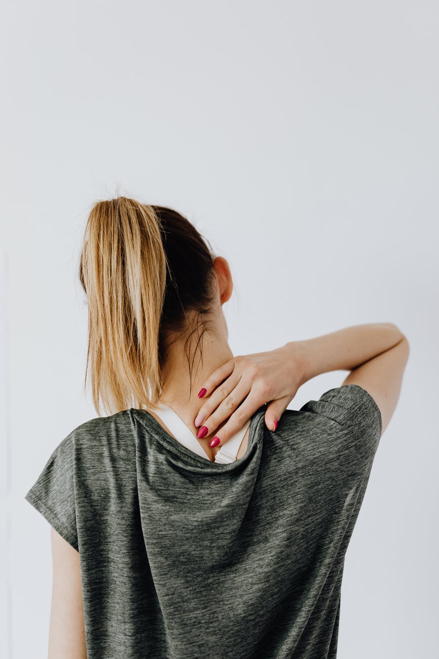 anonymous female with spinal pain on white background