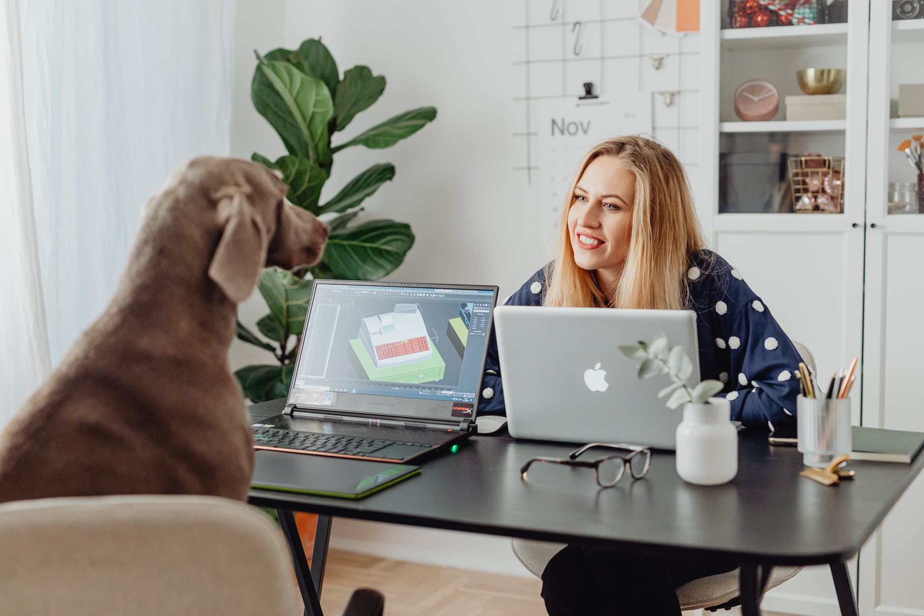 woman in blue and white polka dot shirt using macbook
