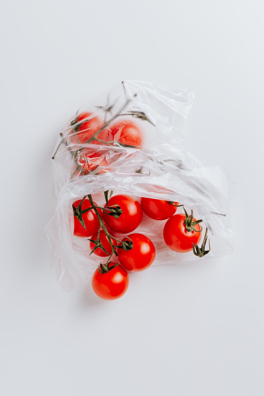 cherry tomatoes in polyethylene bag isolated on white background