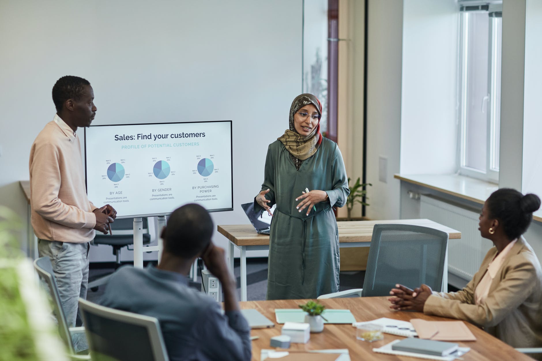 man and woman presenting at the office