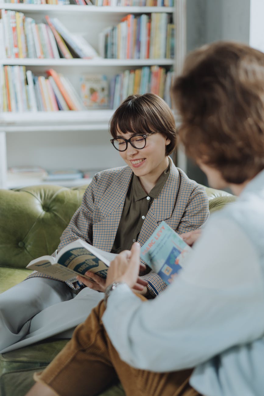 woman in gray blazer reading book