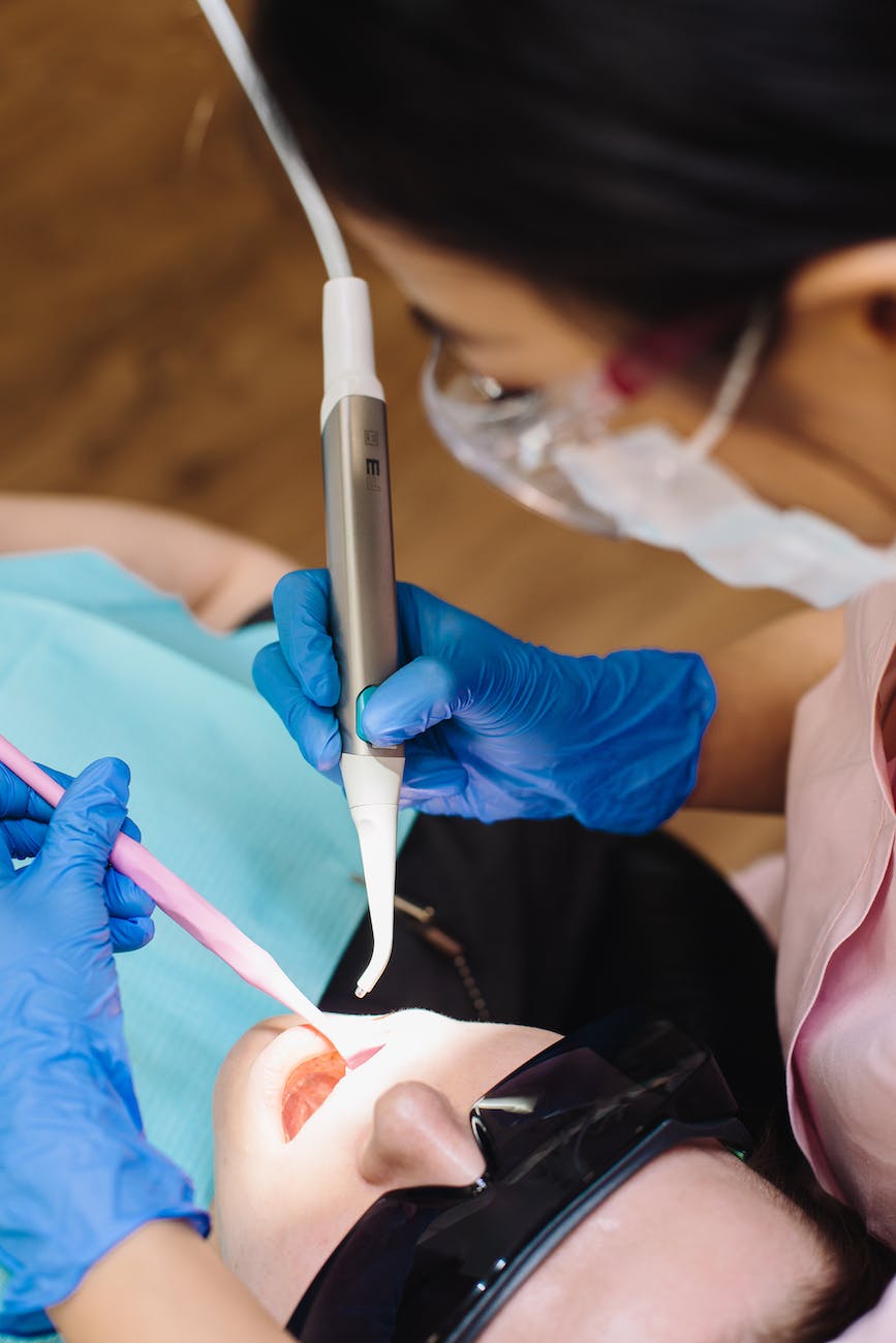 a person holding dental equipment