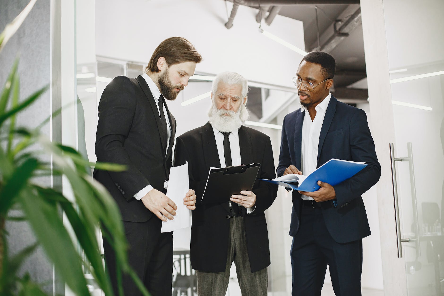 men in office discussing documents