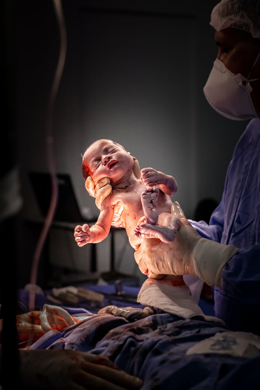 doctor holding newborn baby